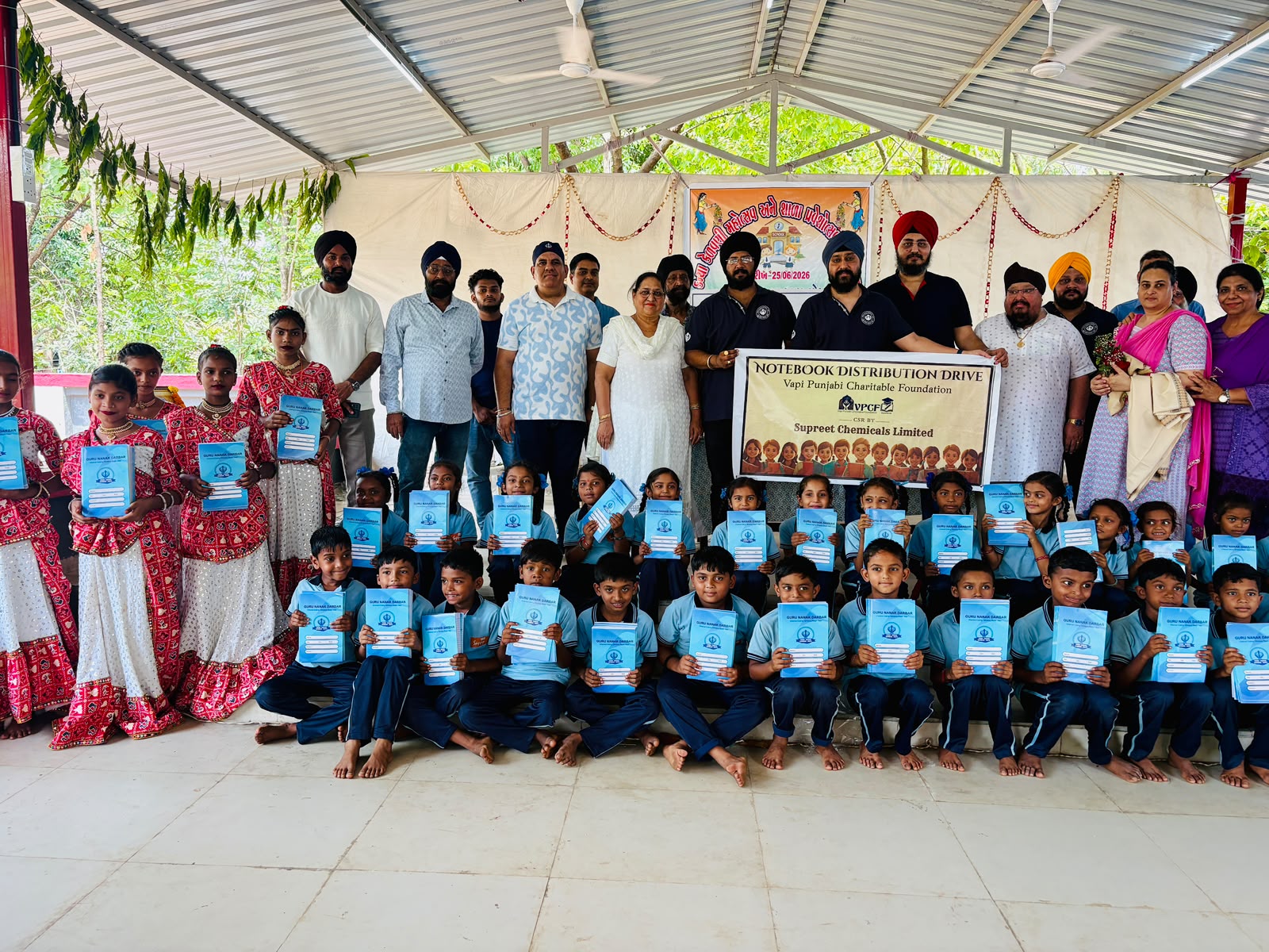 Students holding their new notebooks at a VPCF Notebook Distribution Drive