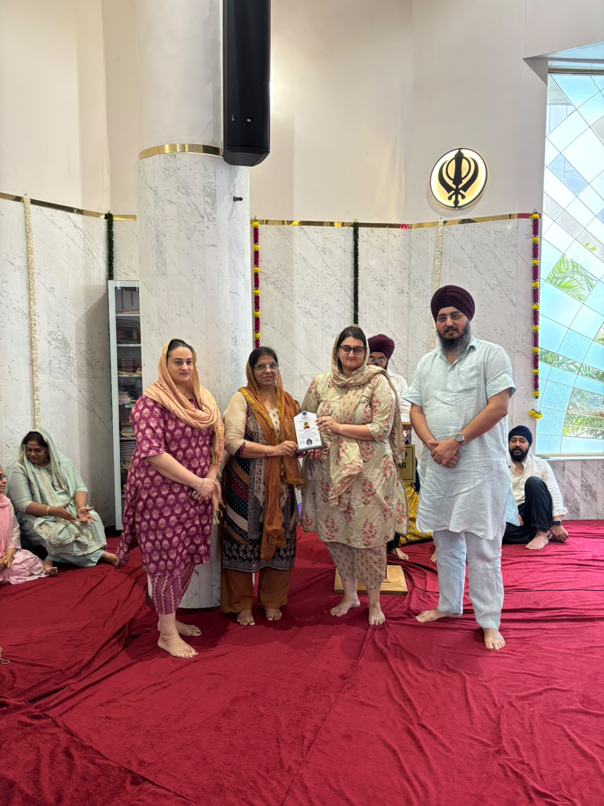 VPCF trustees felicitating a student with a Student Achievement Award plaque